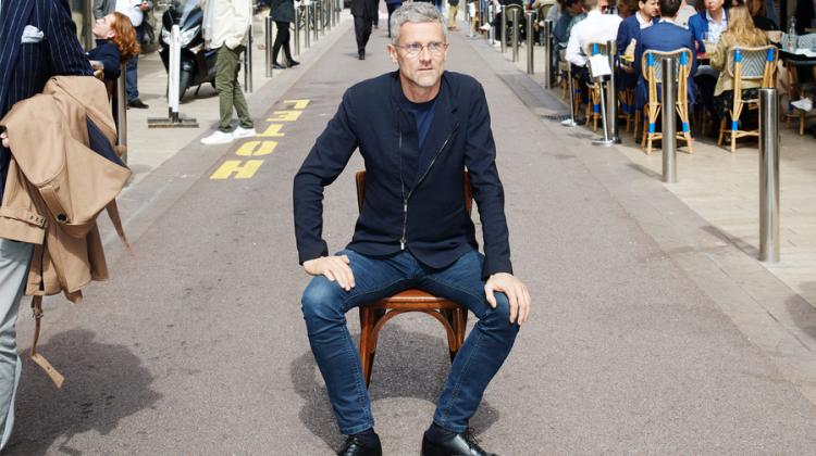 Man sitting on chair in a sidewalk