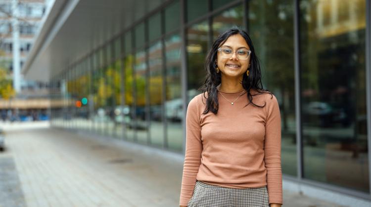 Student standing in front of building