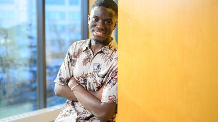 Smiling man leaning against wall