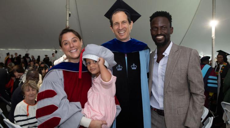 Faculty member with PHD graduate and their loved ones